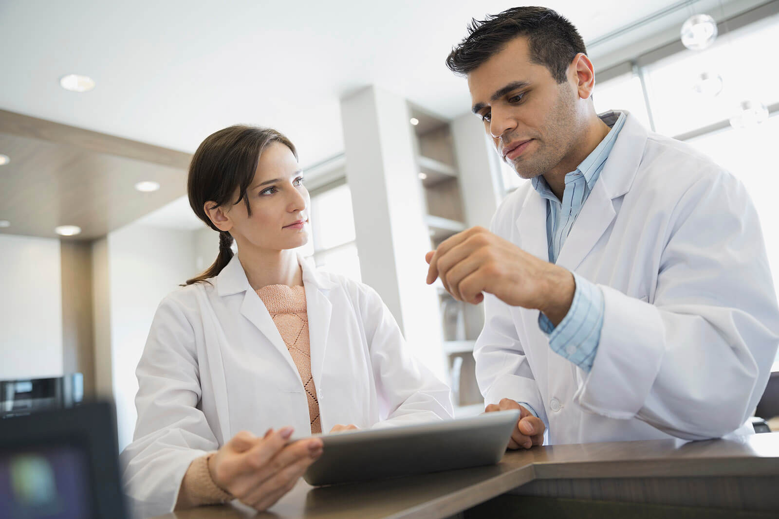 dental-practice-consulting a male and female dentist talking to one another