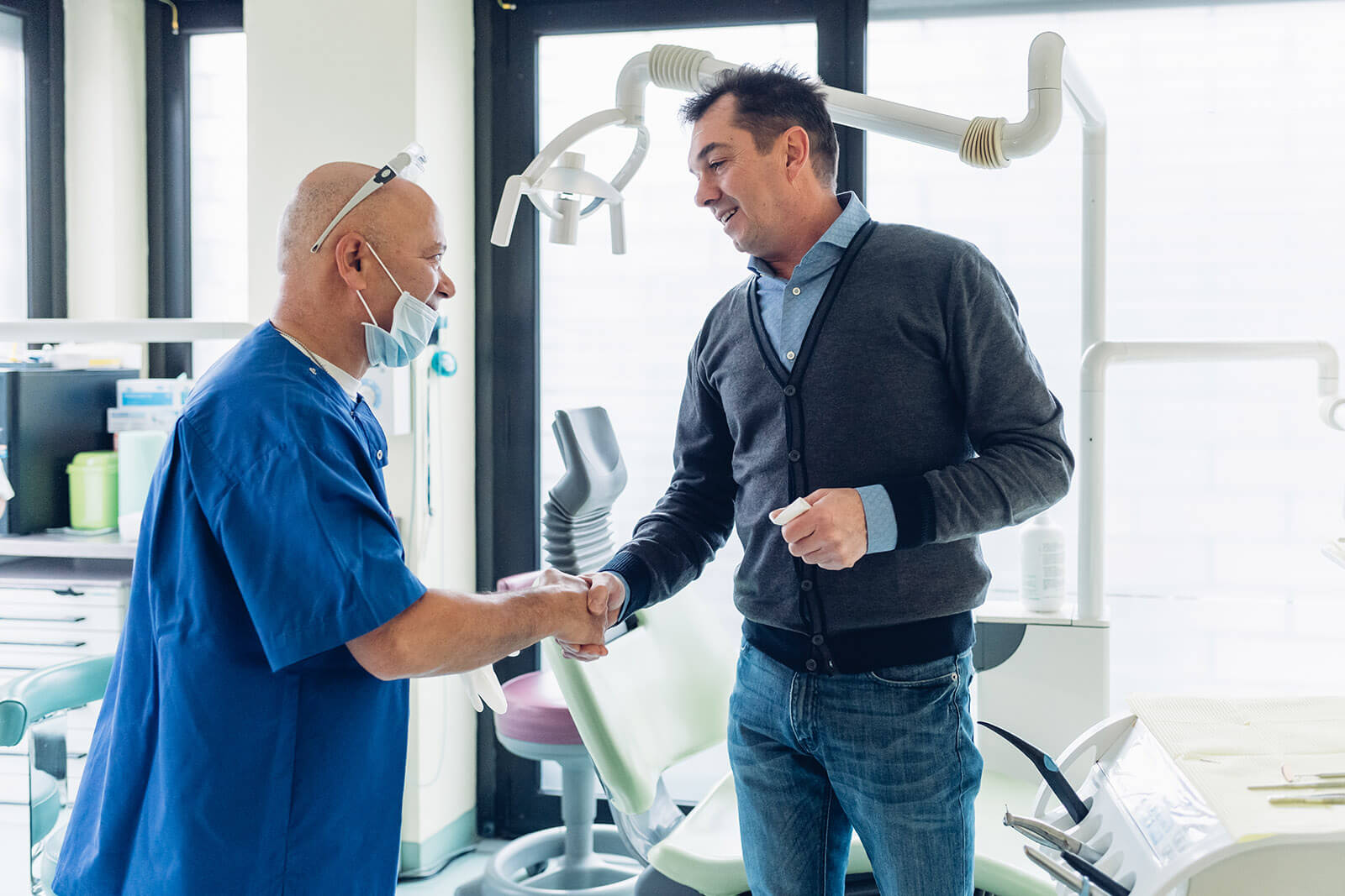 you-are-not-your-patient male dentist shaking hands with male patient