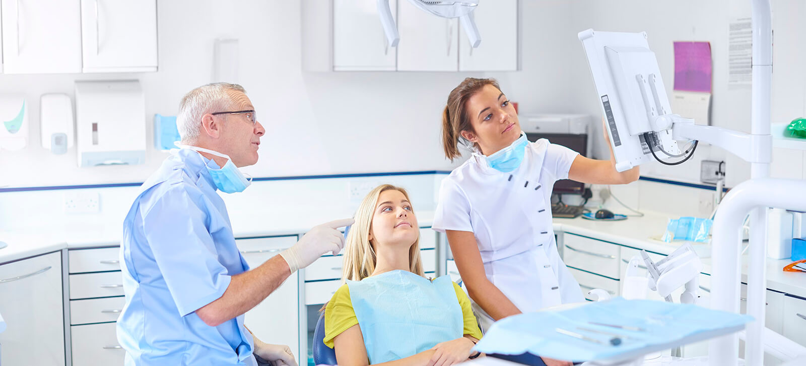 Dentist explains x-ray dentist and hygienist talking to a patient