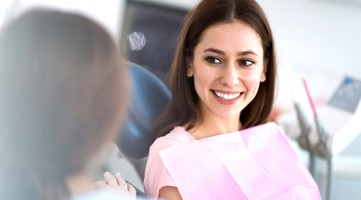 GettyImages-936485334-e1554211940688-cropped dentist and patient in office